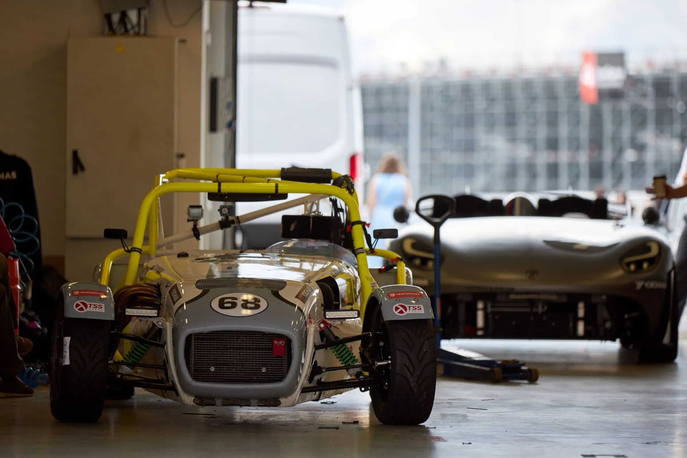 The bureau’s workshop: a caged race car and the prototype beside it
