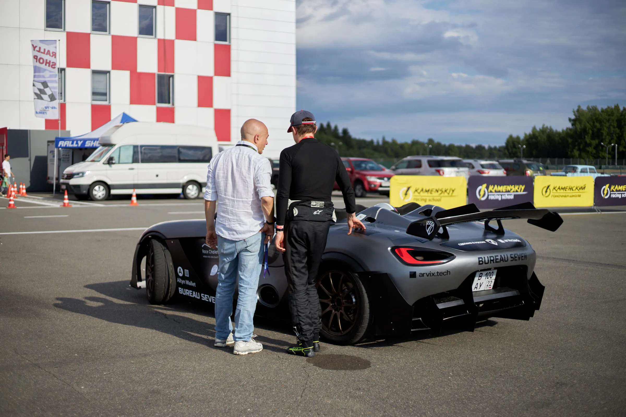 The team beside the car on the pit lane