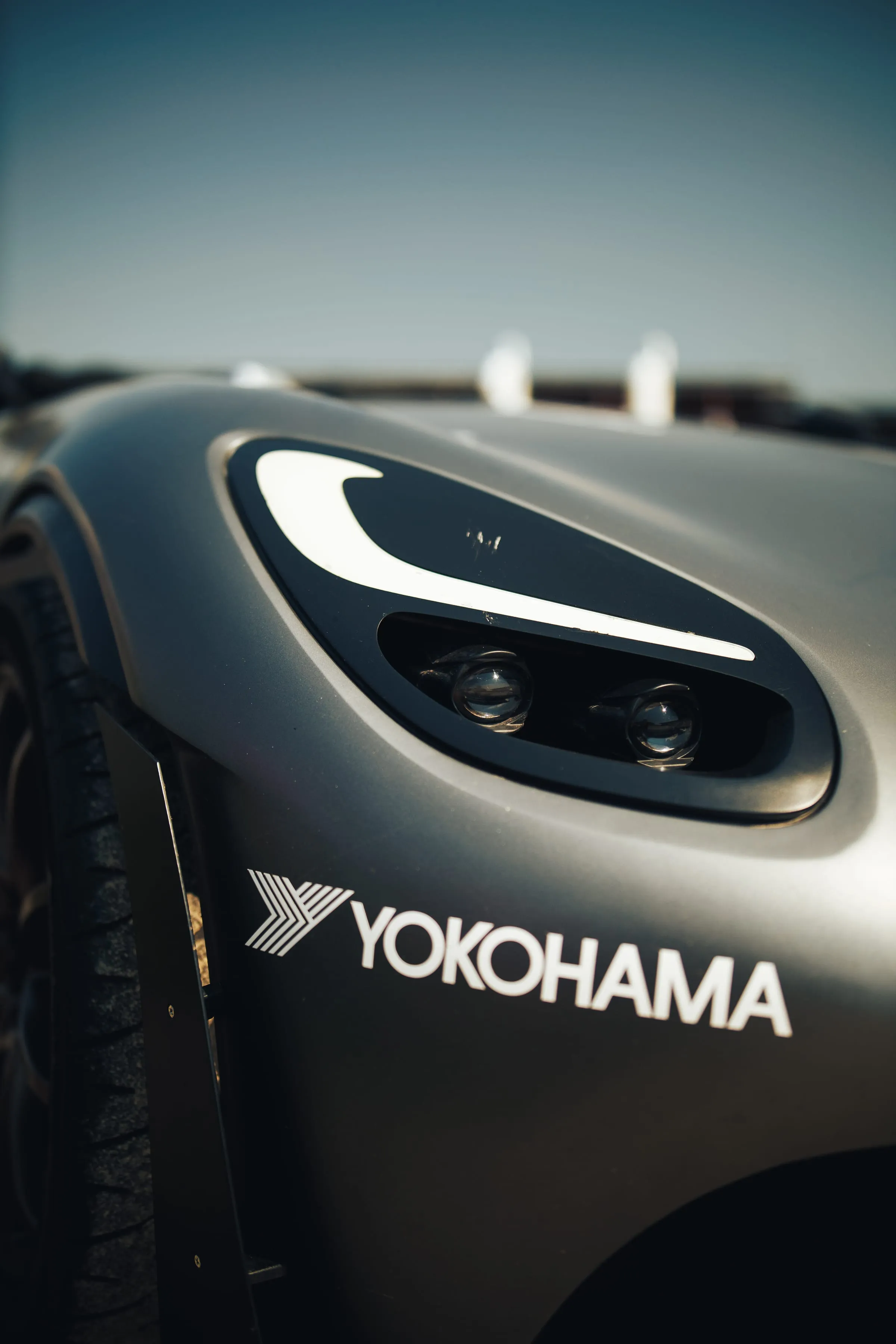 A rear wheel on a Yokohama slick, beside the wing